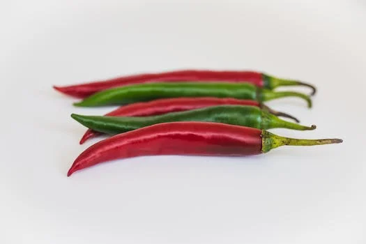A group of four red and green peppers.
